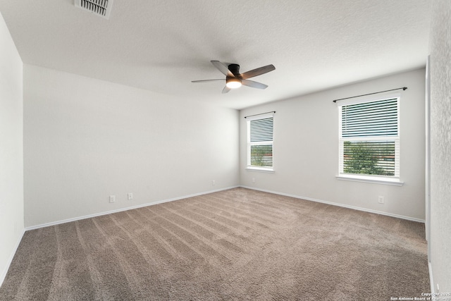 unfurnished room with ceiling fan, carpet, and a textured ceiling