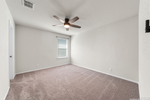 empty room with ceiling fan and carpet flooring