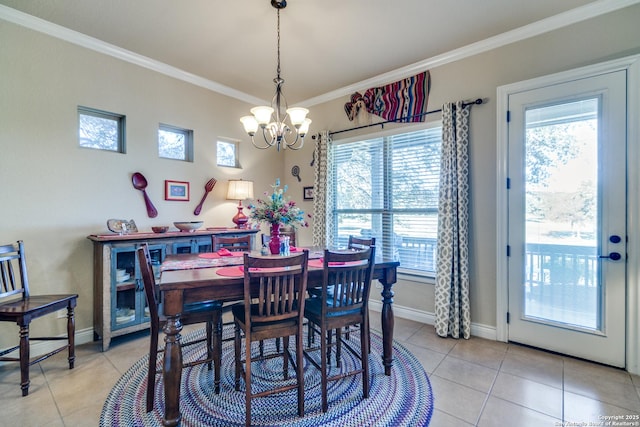 dining room featuring crown molding, an inviting chandelier, and light tile patterned floors