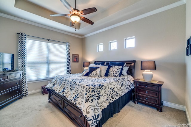 bedroom with light carpet, a tray ceiling, ornamental molding, and ceiling fan