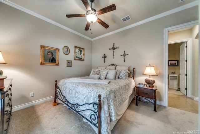 carpeted bedroom with crown molding, ensuite bath, and ceiling fan