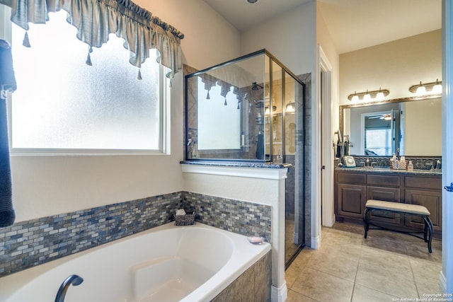 bathroom featuring vanity, independent shower and bath, and tile patterned flooring