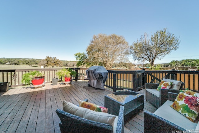 wooden deck with grilling area and outdoor lounge area