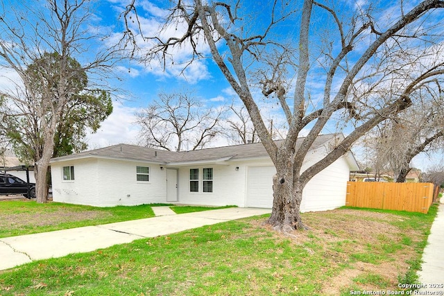 ranch-style home featuring a garage and a front yard