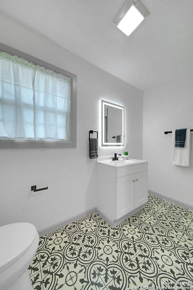 bathroom with vanity and toilet