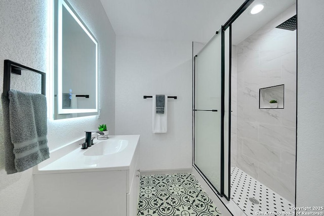 bathroom with vanity, tile patterned flooring, and a shower with door