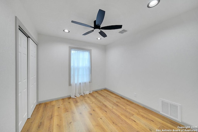 unfurnished bedroom with a closet, ceiling fan, and light wood-type flooring