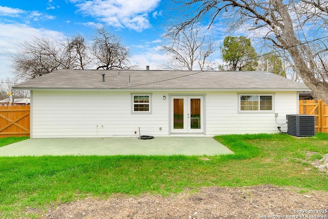 rear view of house with french doors, a lawn, a patio, and central air condition unit