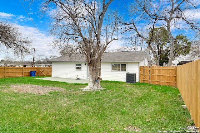 back of property featuring a lawn, central air condition unit, and a patio area