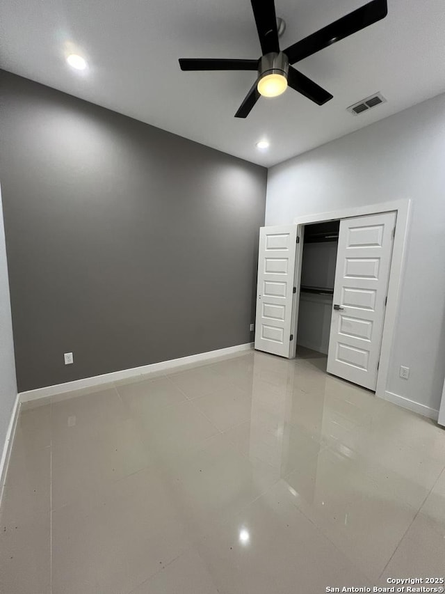 unfurnished bedroom featuring light tile patterned floors, ceiling fan, and a closet