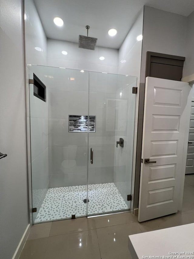 bathroom with tile patterned floors and walk in shower