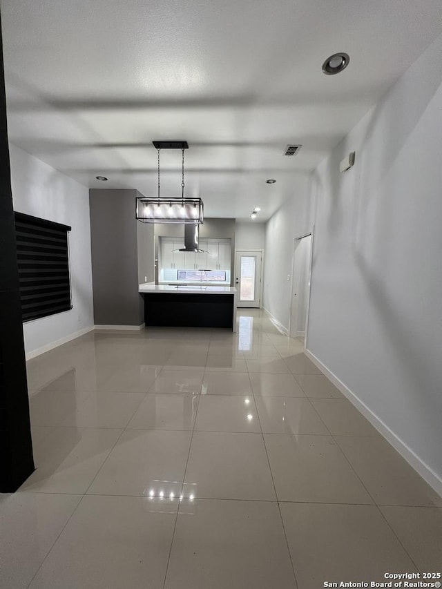 corridor featuring light tile patterned flooring