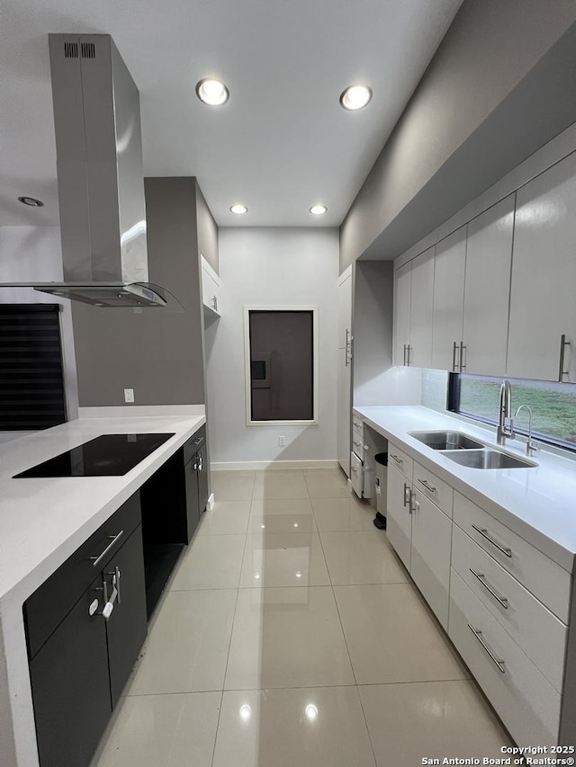 kitchen featuring light tile patterned flooring, sink, white cabinetry, island range hood, and black electric stovetop