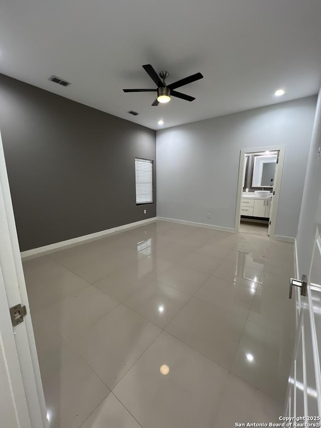 empty room with light tile patterned floors and ceiling fan