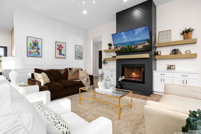 living room with a fireplace and light hardwood / wood-style flooring