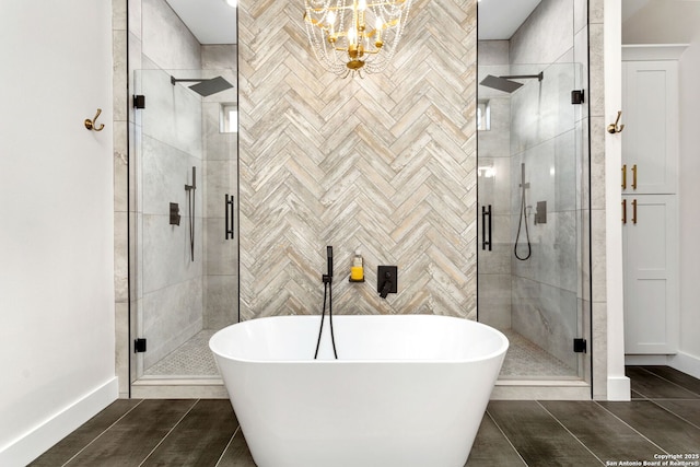 bathroom featuring independent shower and bath, tile patterned floors, and an inviting chandelier