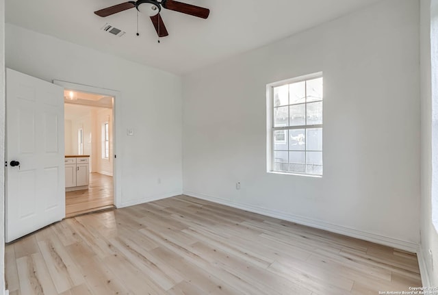 spare room featuring light hardwood / wood-style flooring and ceiling fan