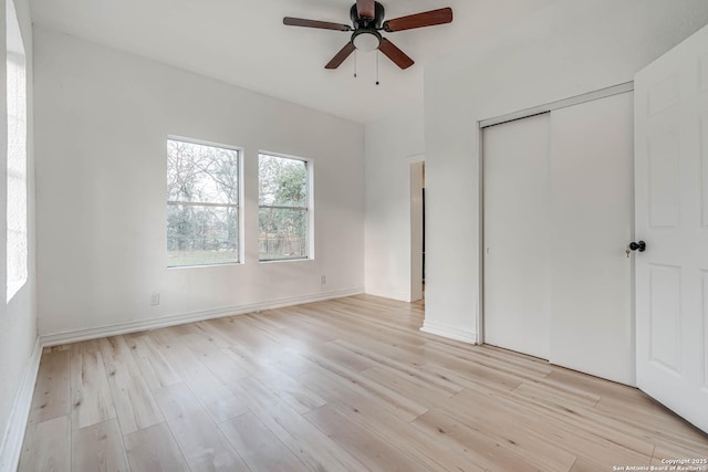 unfurnished bedroom featuring ceiling fan, light wood-type flooring, and a closet