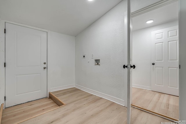 interior space featuring electric dryer hookup, hardwood / wood-style floors, hookup for a washing machine, and hookup for a gas dryer