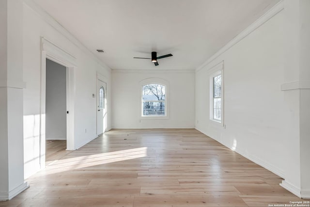 empty room featuring crown molding and light hardwood / wood-style floors