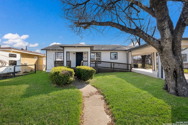 view of front of property with a front yard and a carport