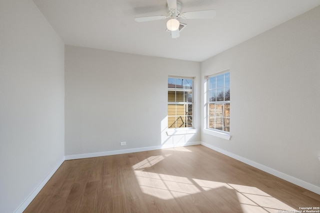 spare room with ceiling fan and wood-type flooring