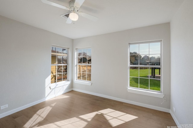empty room featuring hardwood / wood-style floors and ceiling fan
