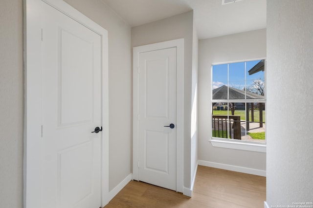 corridor featuring light hardwood / wood-style floors