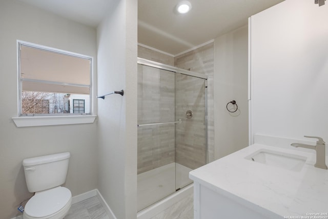 bathroom featuring vanity, toilet, and walk in shower
