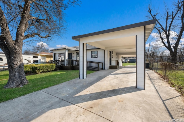 exterior space with a carport and a yard