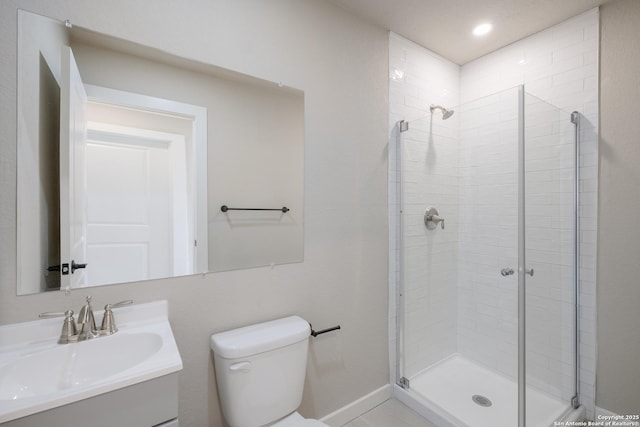 bathroom featuring vanity, toilet, and a shower with shower door
