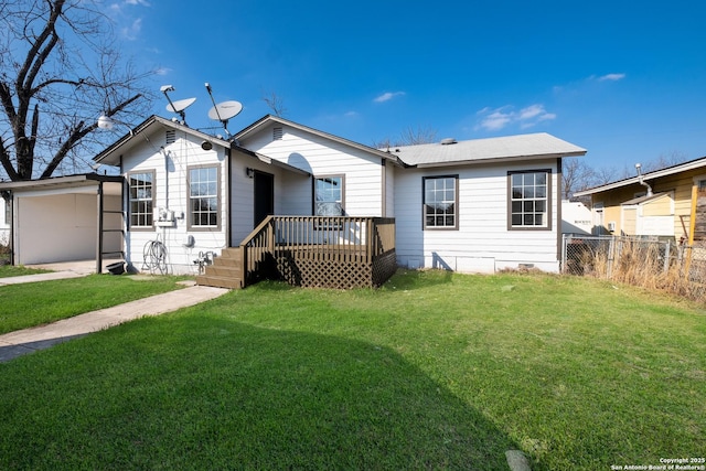 rear view of house with a deck and a lawn