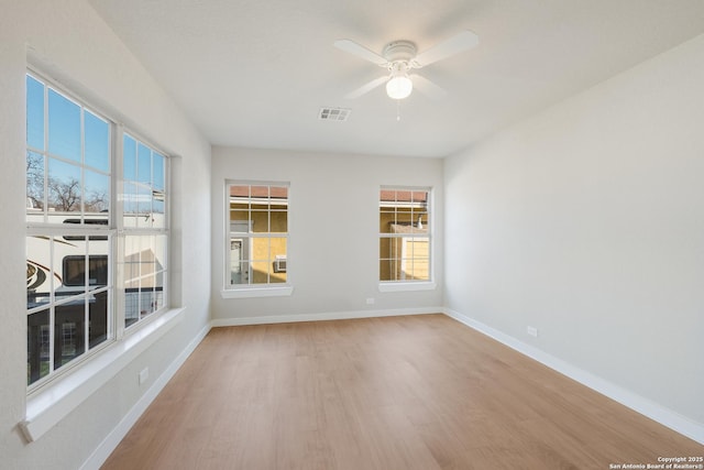 unfurnished room with hardwood / wood-style flooring and ceiling fan