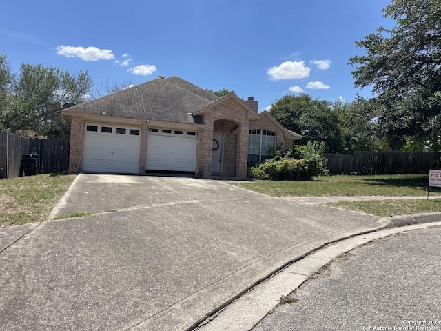 view of front of home with a garage and a front lawn