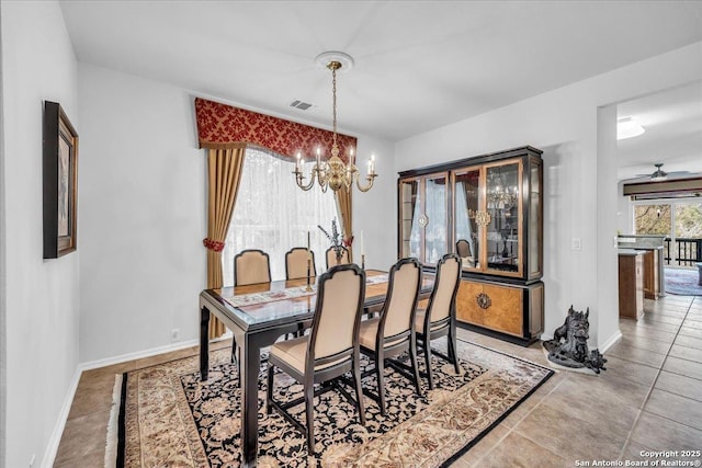 dining area featuring ceiling fan with notable chandelier and light tile patterned floors