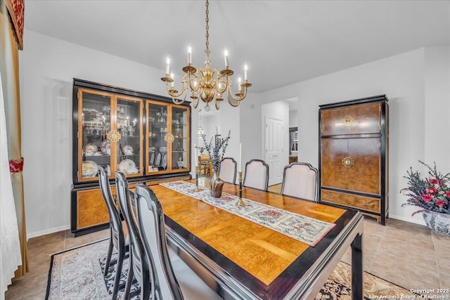 tiled dining room featuring a notable chandelier