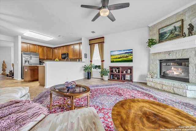 living room featuring light tile patterned floors and ceiling fan