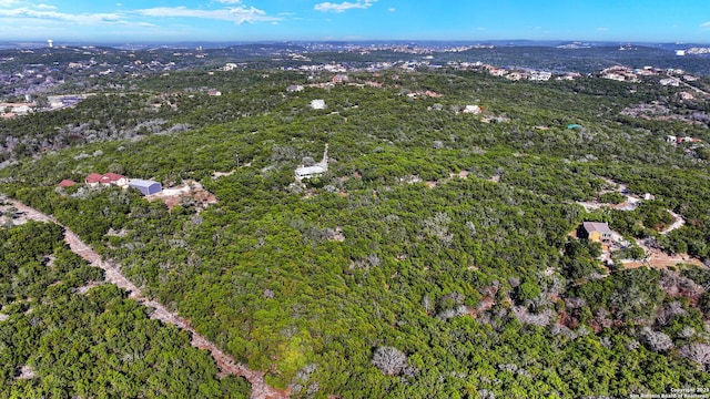 drone / aerial view with a wooded view