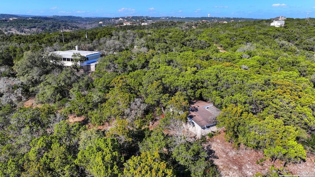 drone / aerial view featuring a forest view