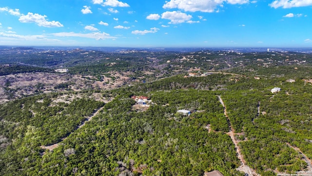 drone / aerial view featuring a wooded view