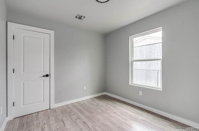 spare room featuring light hardwood / wood-style floors
