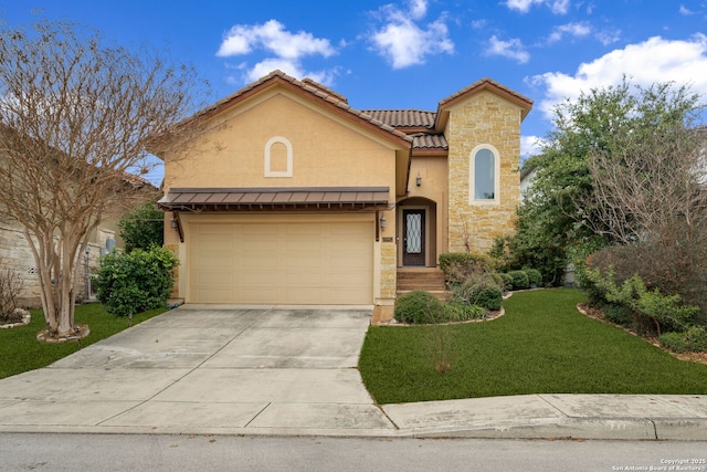 mediterranean / spanish home featuring a garage and a front lawn