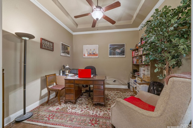 office area with a raised ceiling, crown molding, ceiling fan, and light hardwood / wood-style floors