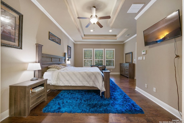 bedroom featuring a tray ceiling, ornamental molding, dark hardwood / wood-style floors, and ceiling fan