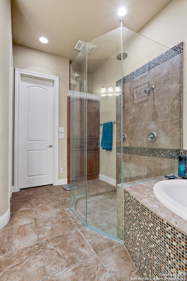 bathroom with shower with separate bathtub