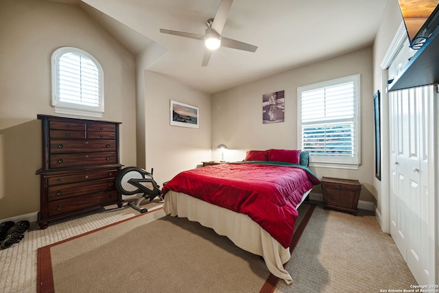 bedroom featuring light carpet, multiple windows, and ceiling fan