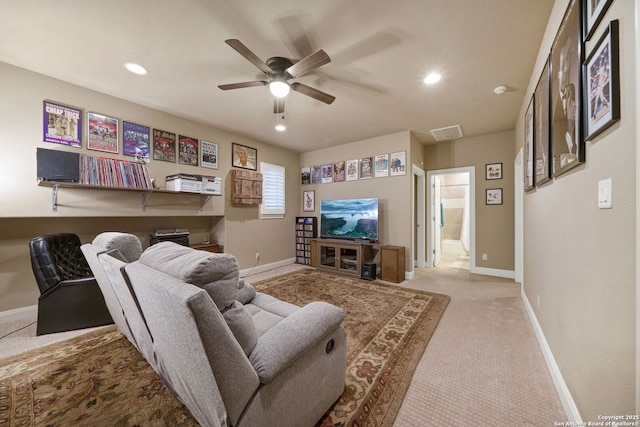 living room featuring light carpet and ceiling fan