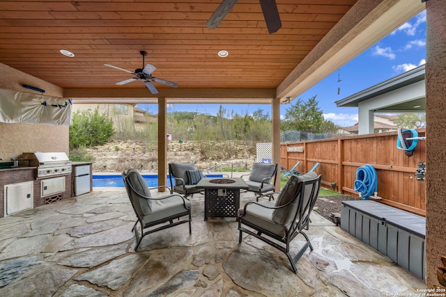 view of patio featuring a grill, ceiling fan, and an outdoor fire pit