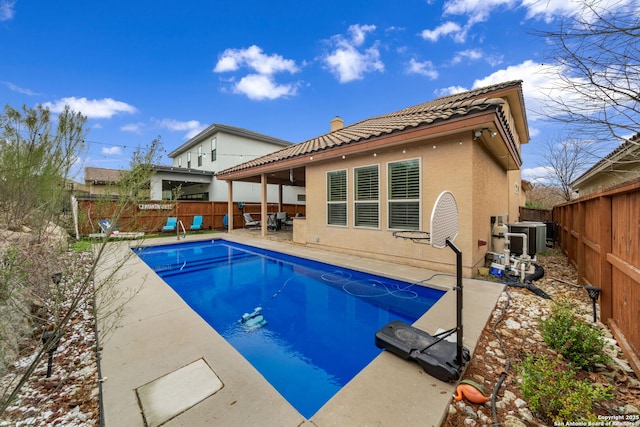 view of pool with central AC unit and a patio area