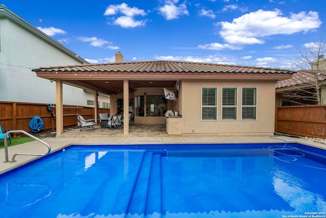 view of swimming pool featuring a patio and ceiling fan